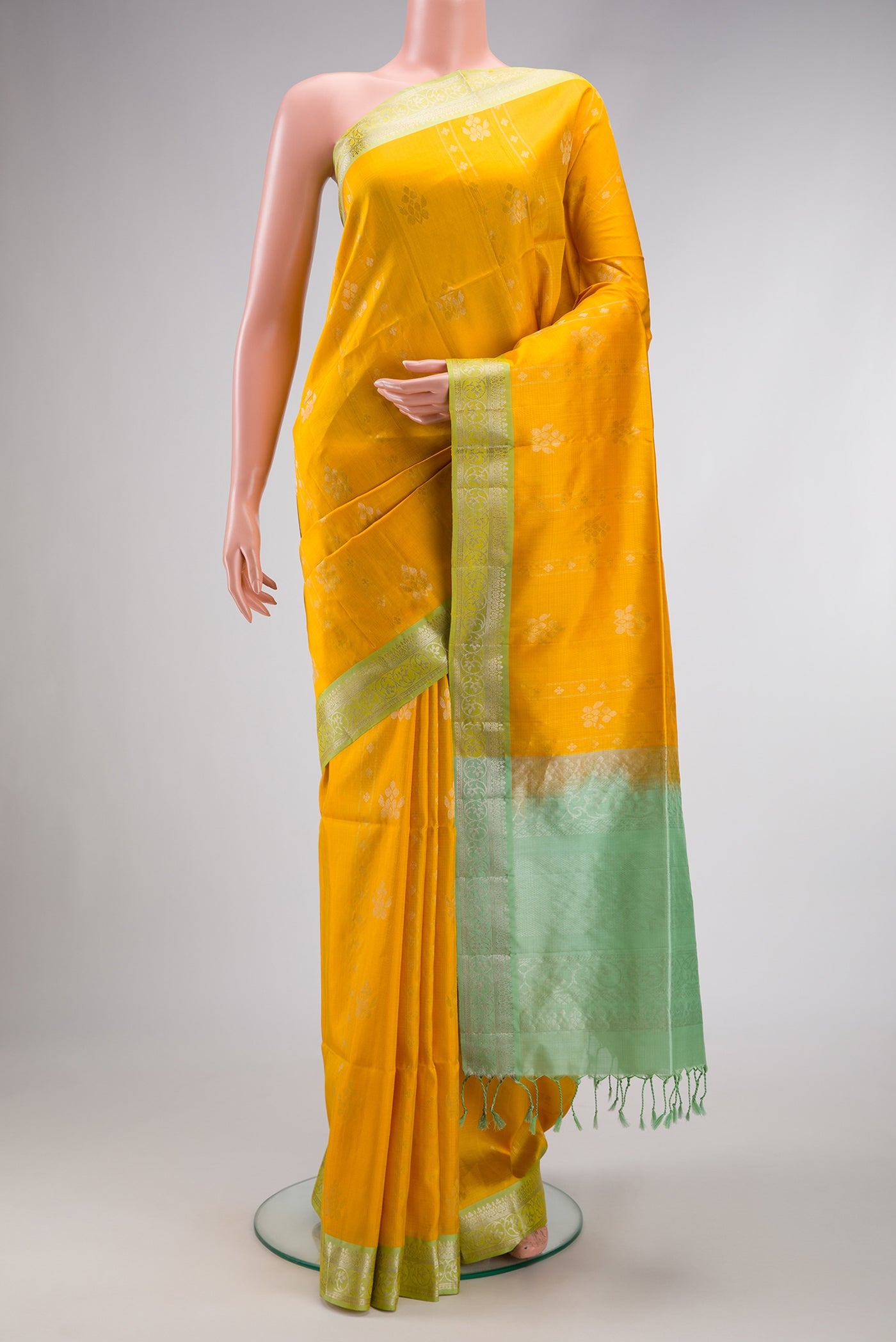 Yellow Dual Tone Soft Silk Saree with Zari Butta on the body and Zari Border.  displayed on a mannequin