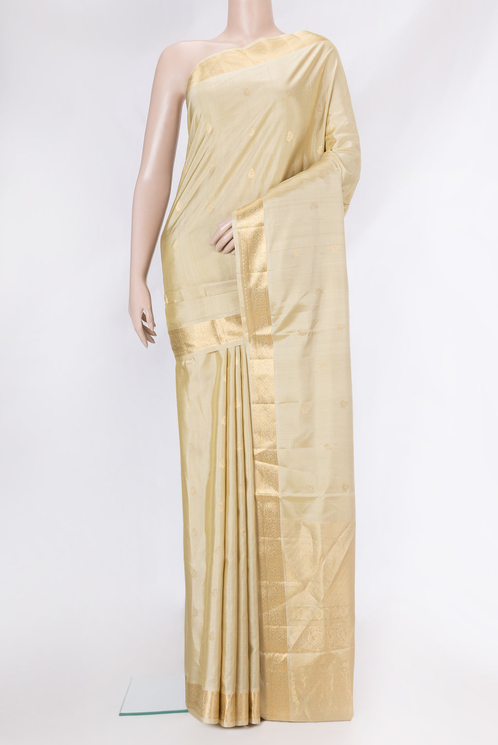 Beige Soft Silk Saree with Zari Butta on the body and Zari Border.  displayed on a mannequin