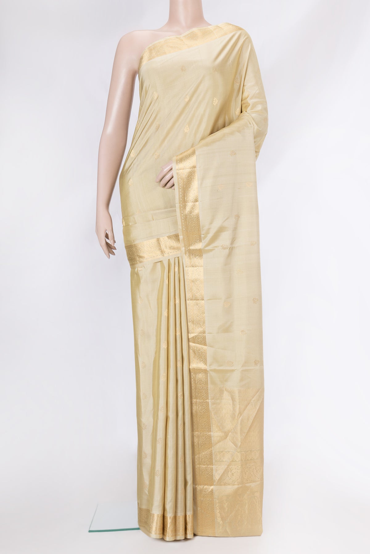 Beige Soft Silk Saree with Zari Butta on the body and Zari Border.  displayed on a mannequin