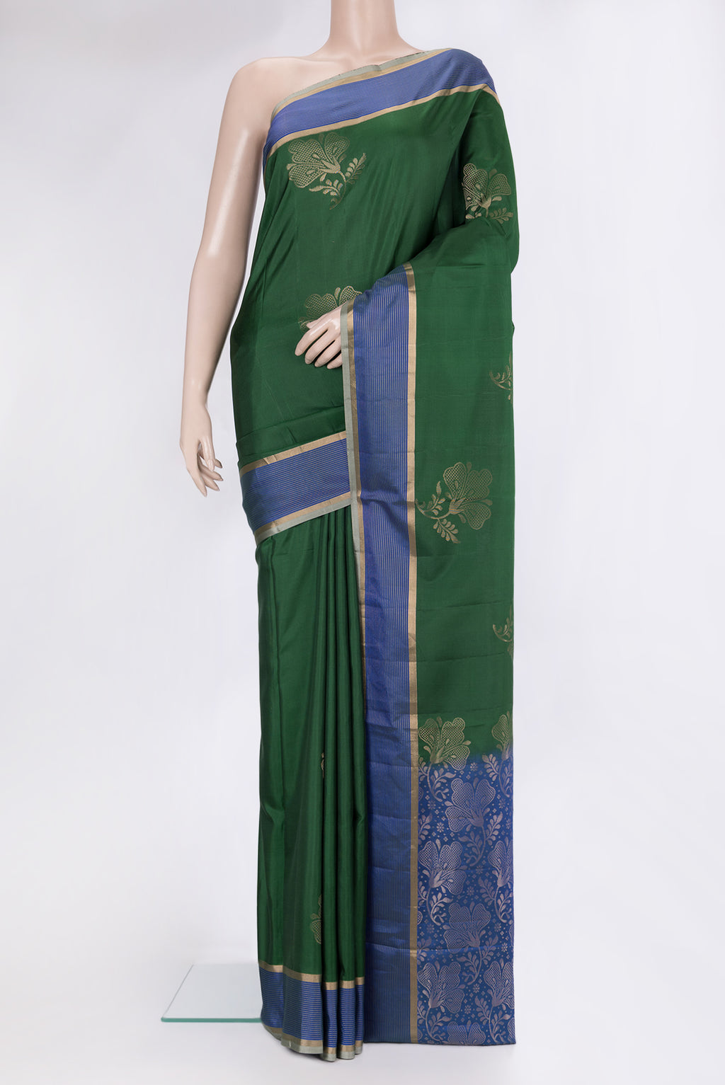Bottle Green Soft Silk Saree with Zari Butta on the body and Fancy Border.  displayed on a mannequin
