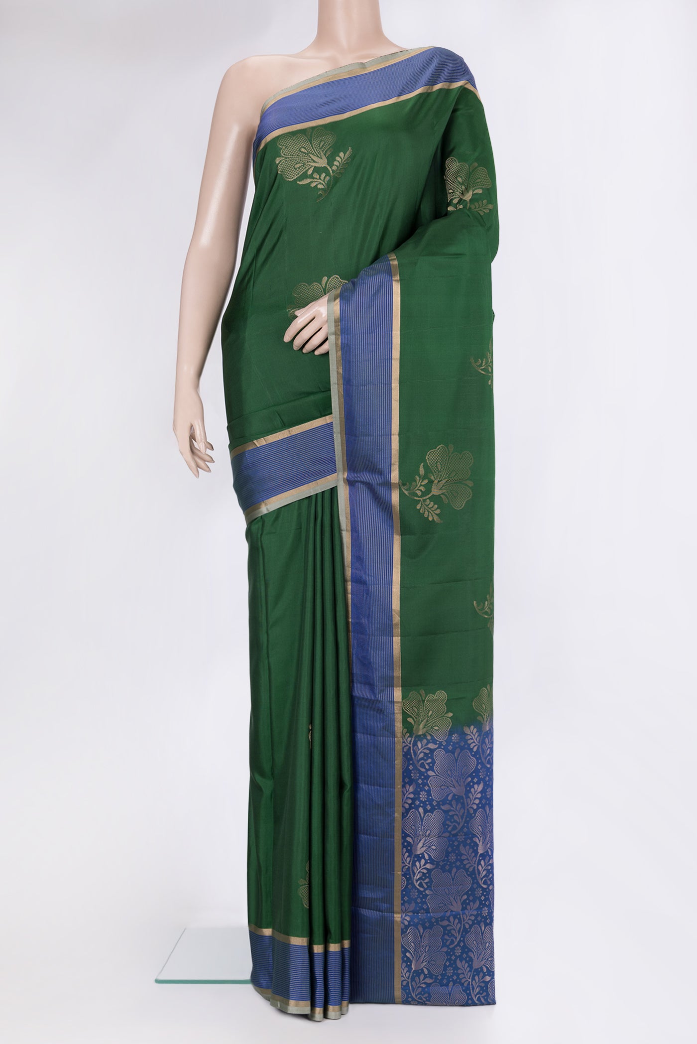 Bottle Green Soft Silk Saree with Zari Butta on the body and Fancy Border.  displayed on a mannequin