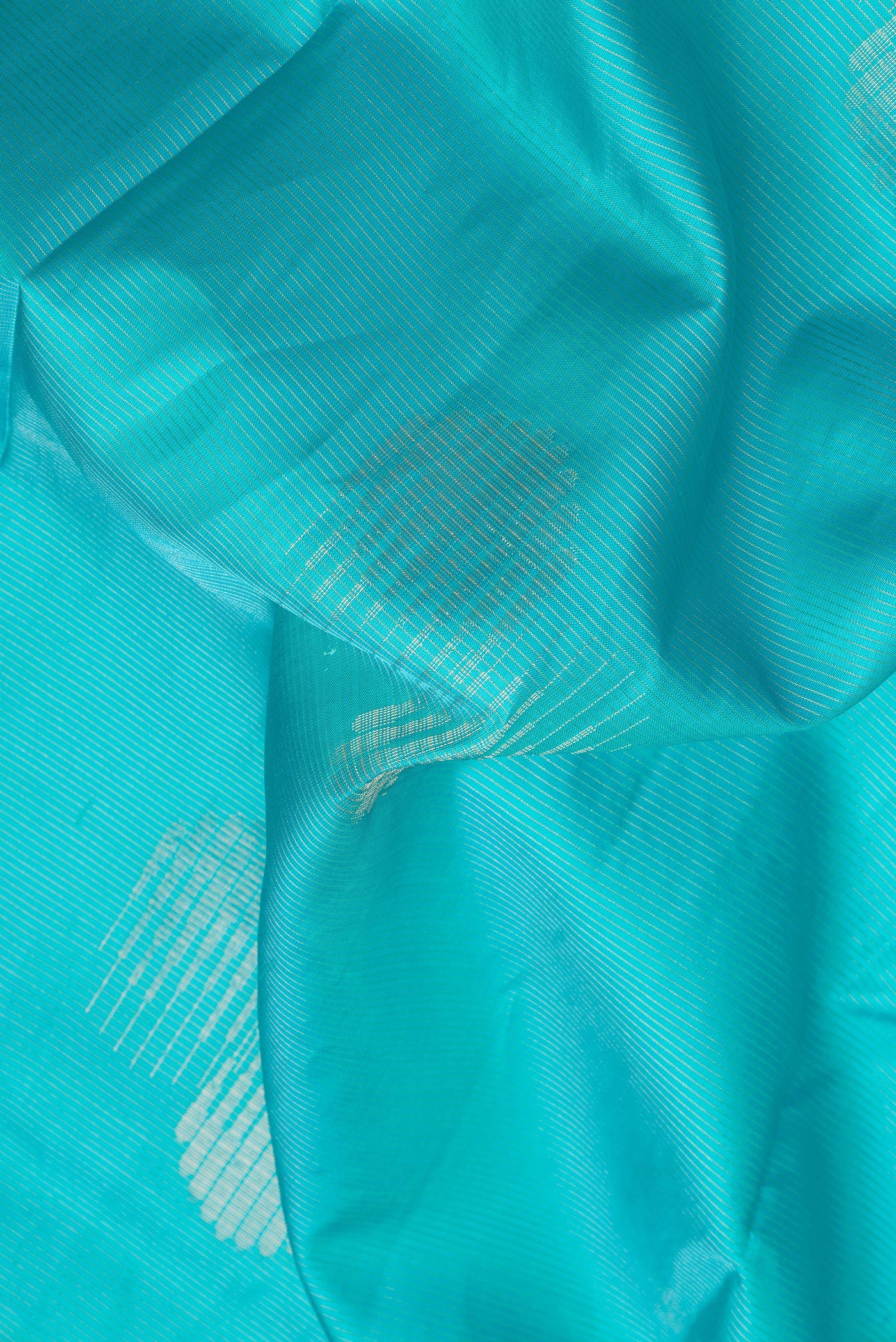 Close up of Sky Blue Dual Tone Soft Silk Saree with Stripes on the body and Fancy Border.  displaying folds