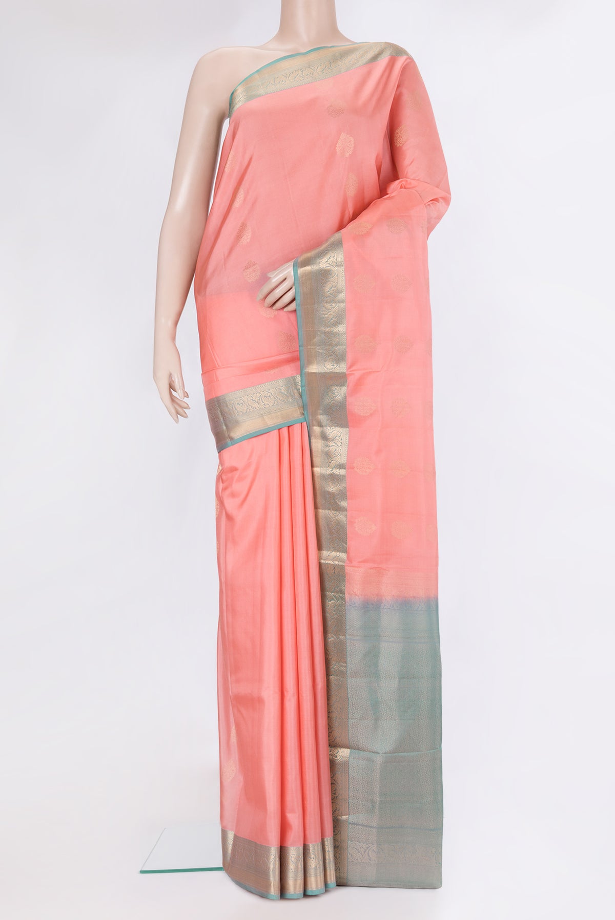 Golden Peach Soft Silk Saree with Zari Butta on the body and Zari Border.  displayed on a mannequin