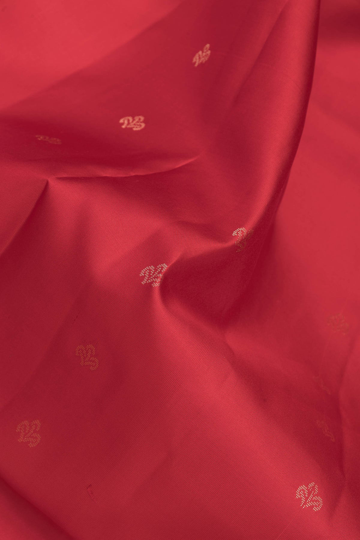 Close up of Maroon Dual Tone Soft Silk Saree with Zari Butta on the body and Fancy Border.  displaying folds