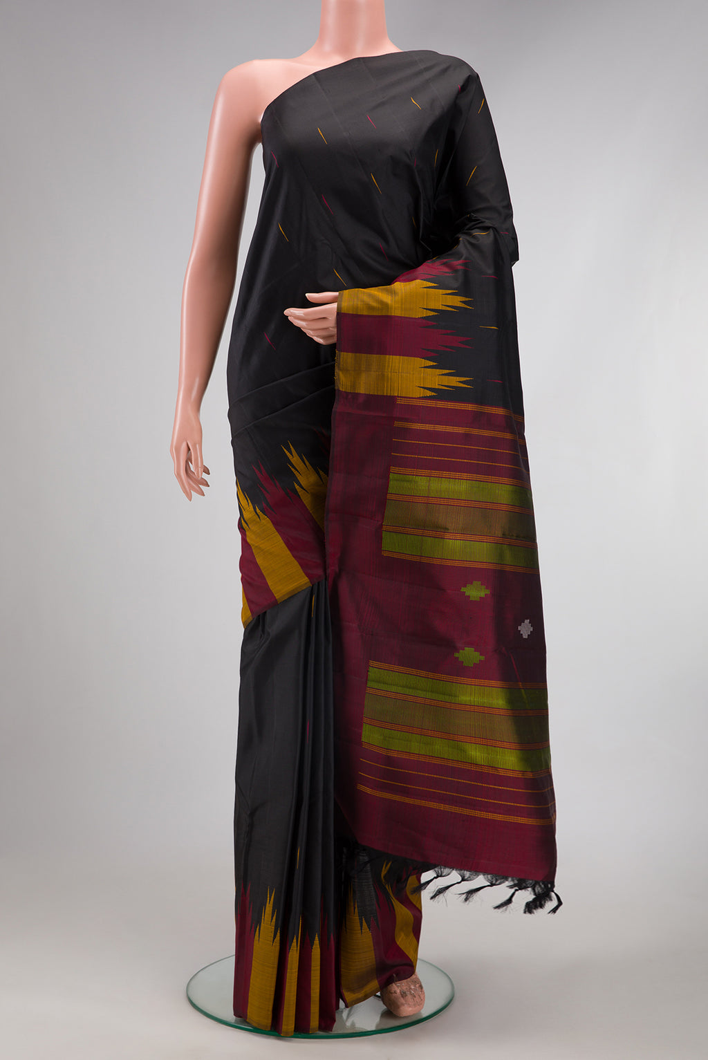 Black Kanchipuram Silk Saree with Thread Butta on the body and Temple Border.  displayed on a mannequin
