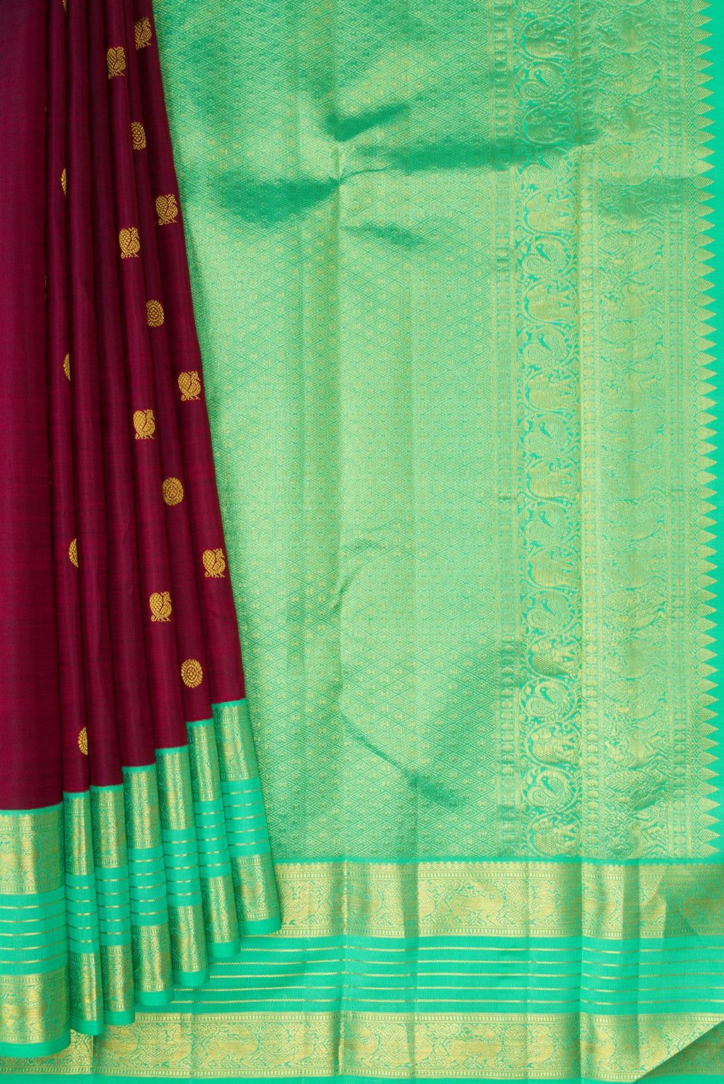 Pleats and pallu of Maroon Kanjivaram Silk Saree with Zari Butta on the body and Zari Border. 