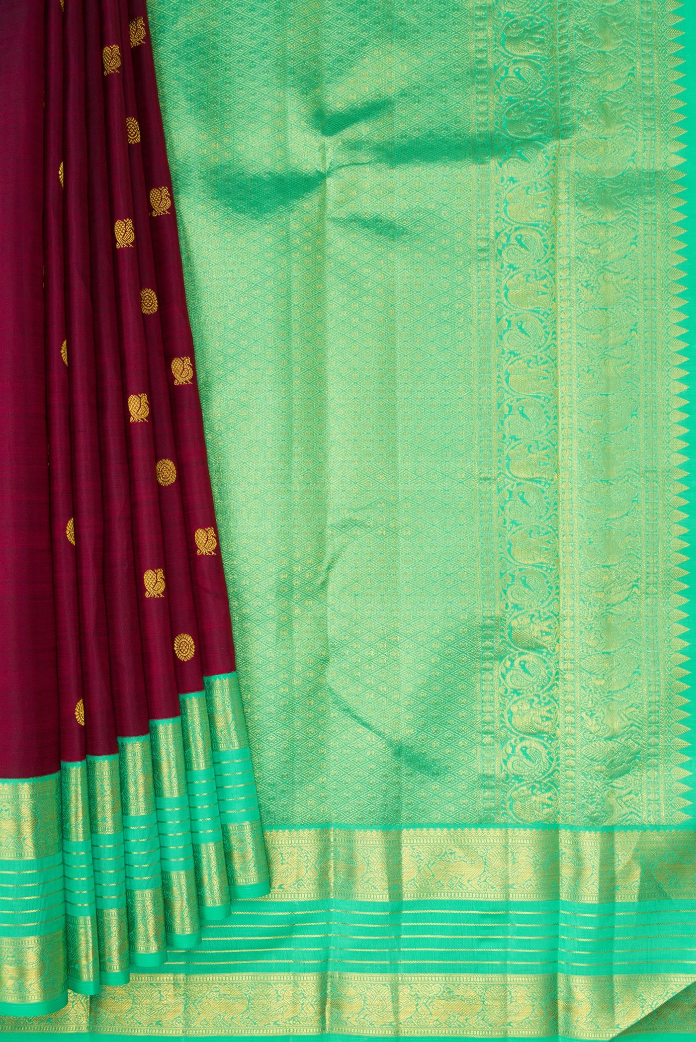 Pleats and pallu of Maroon Kanjivaram Silk Saree with Zari Butta on the body and Zari Border. 