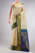 Beige Dual Tone Kanchipuram Silk Saree with Zari Butta on the body and Zari Border.  displayed on a mannequin