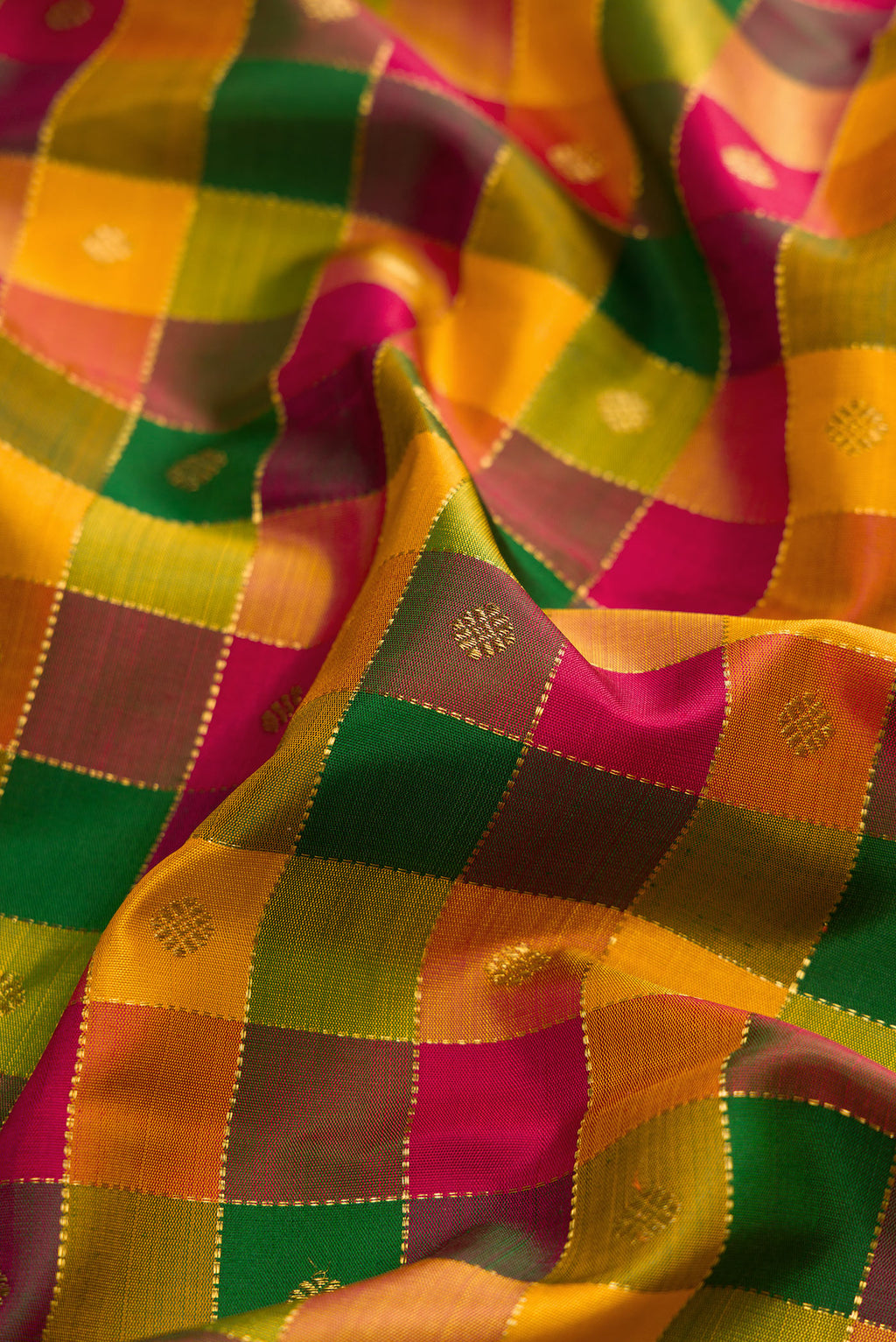 Close up of Yellow , Green and Red Color Kanchipuram Silk Saree with Checked design on the body and Zari Border.  displaying folds