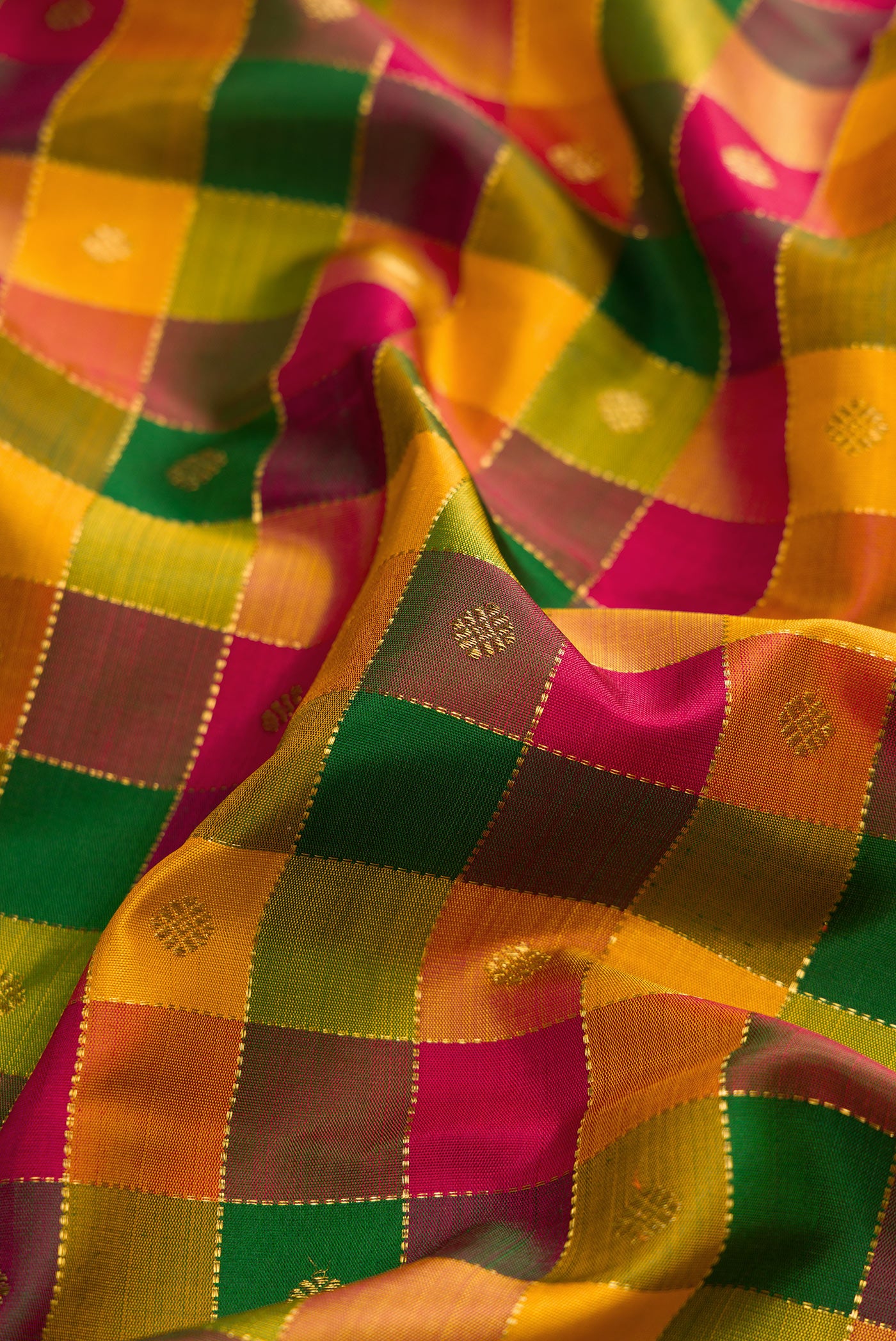 Close up of Yellow , Green and Red Color Kanchipuram Silk Saree with Checked design on the body and Zari Border.  displaying folds