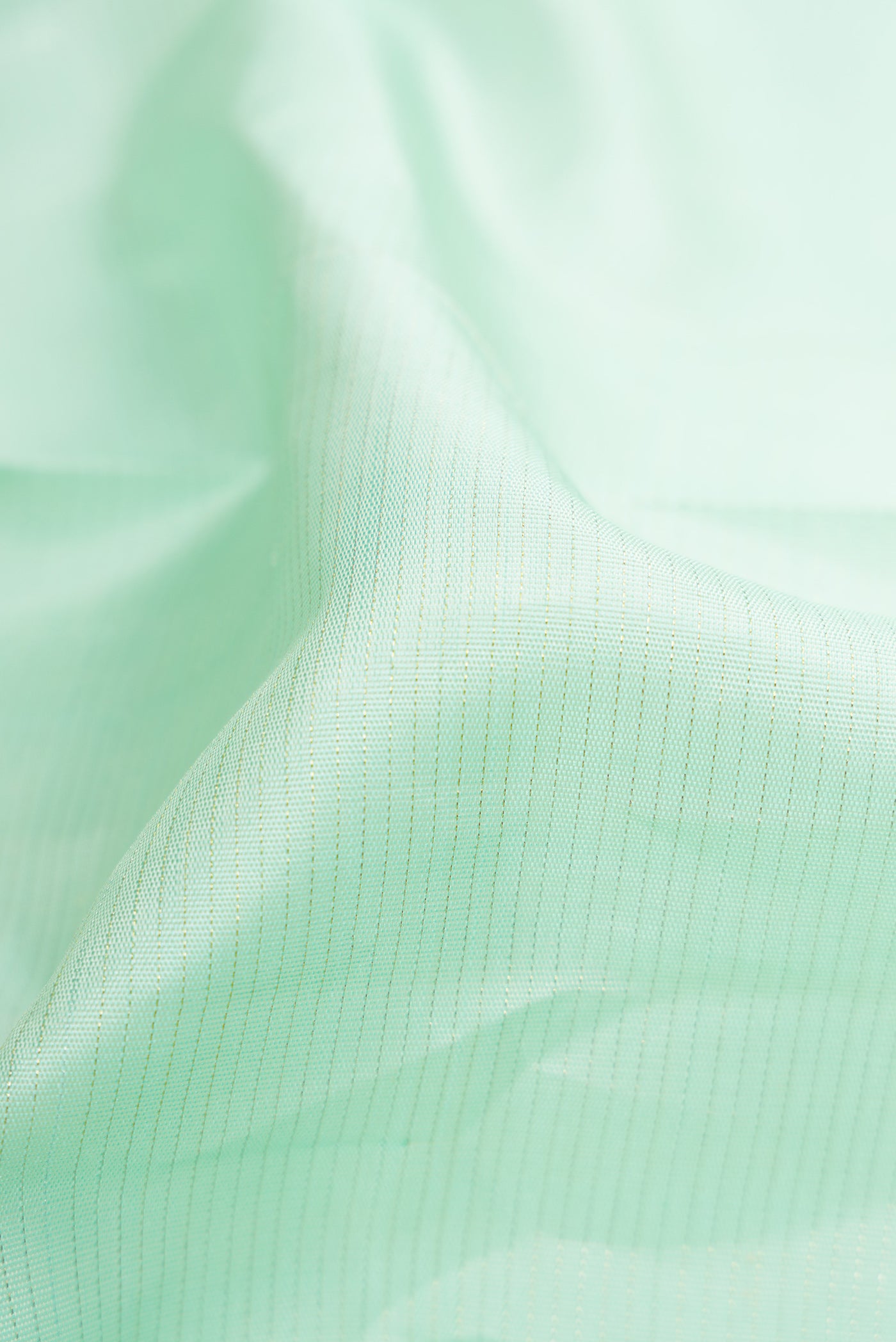 Close up of Light Blue Dual Tone Kanjivaram Silk Saree with Stripes on the body and Rising Temple Border.  displaying folds
