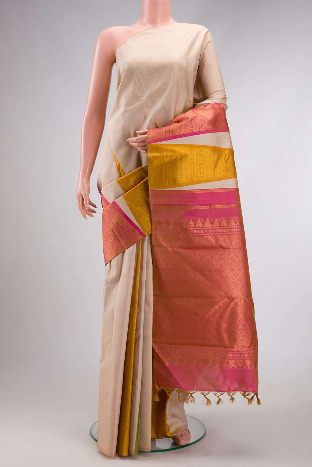 Pure Silk Pure Zari Beige Dual Tone Kanchipuram Saree with Plain Body and One Side Border.  displayed on a mannequin