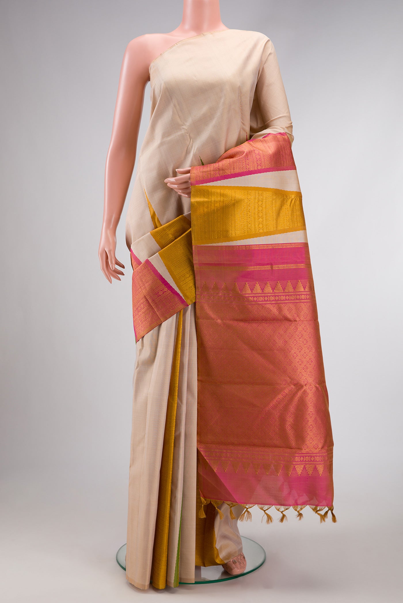 Pure Silk Pure Zari Beige Dual Tone Kanchipuram Saree with Plain Body and One Side Border.  displayed on a mannequin