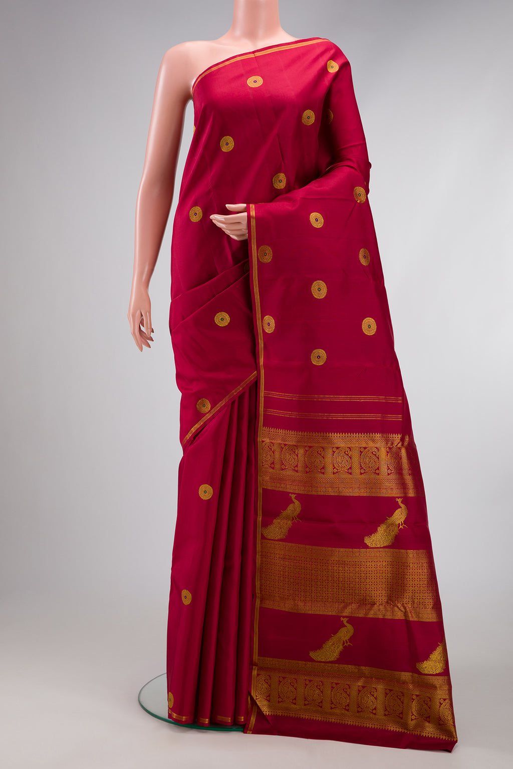 Maroon Kanchipuram Silk Saree with Zari And Thread Butta on the body and Thin Zari Line.  displayed on a mannequin