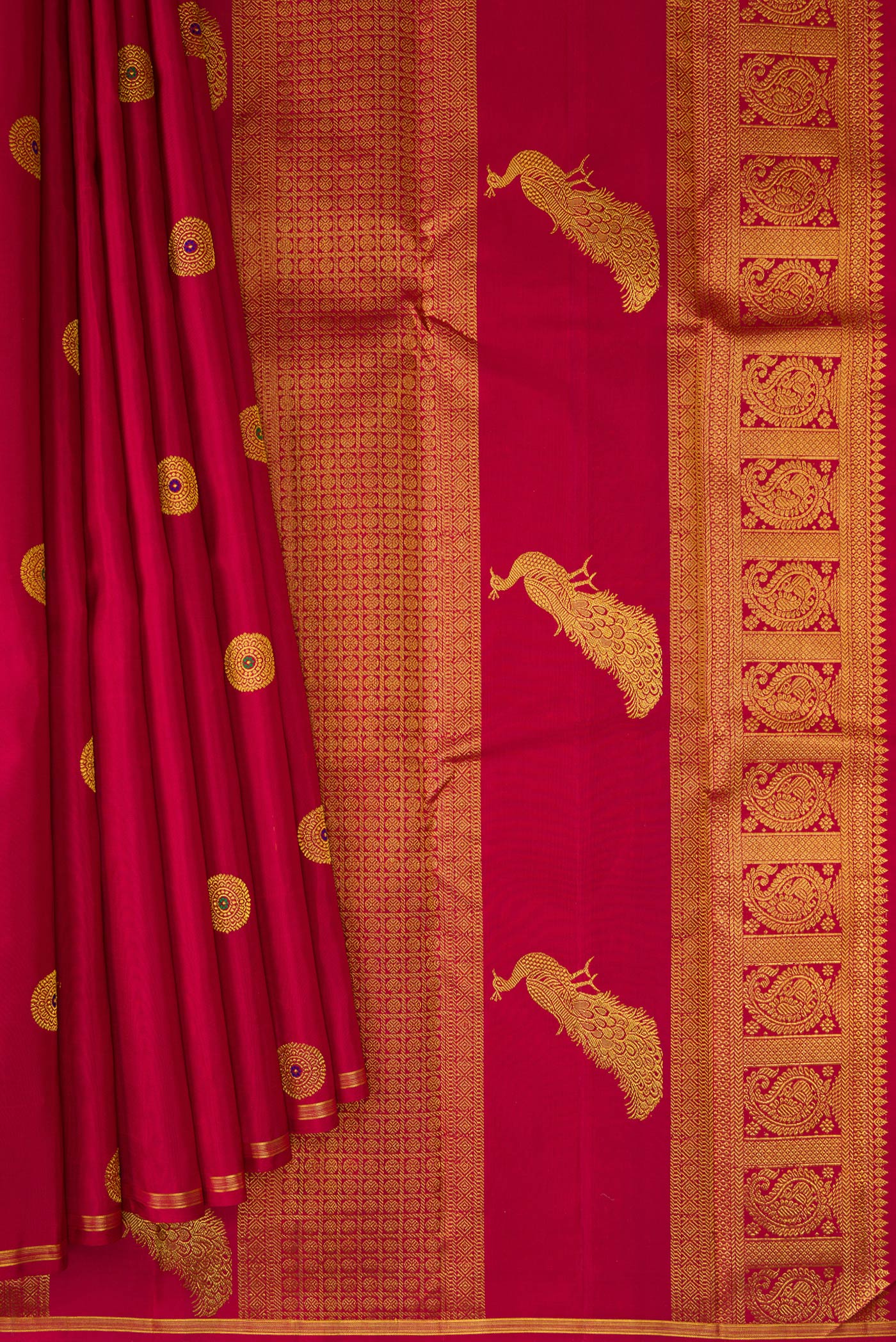 Pleats and pallu of Maroon Kanchipuram Silk Saree with Zari And Thread Butta on the body and Thin Zari Line. 