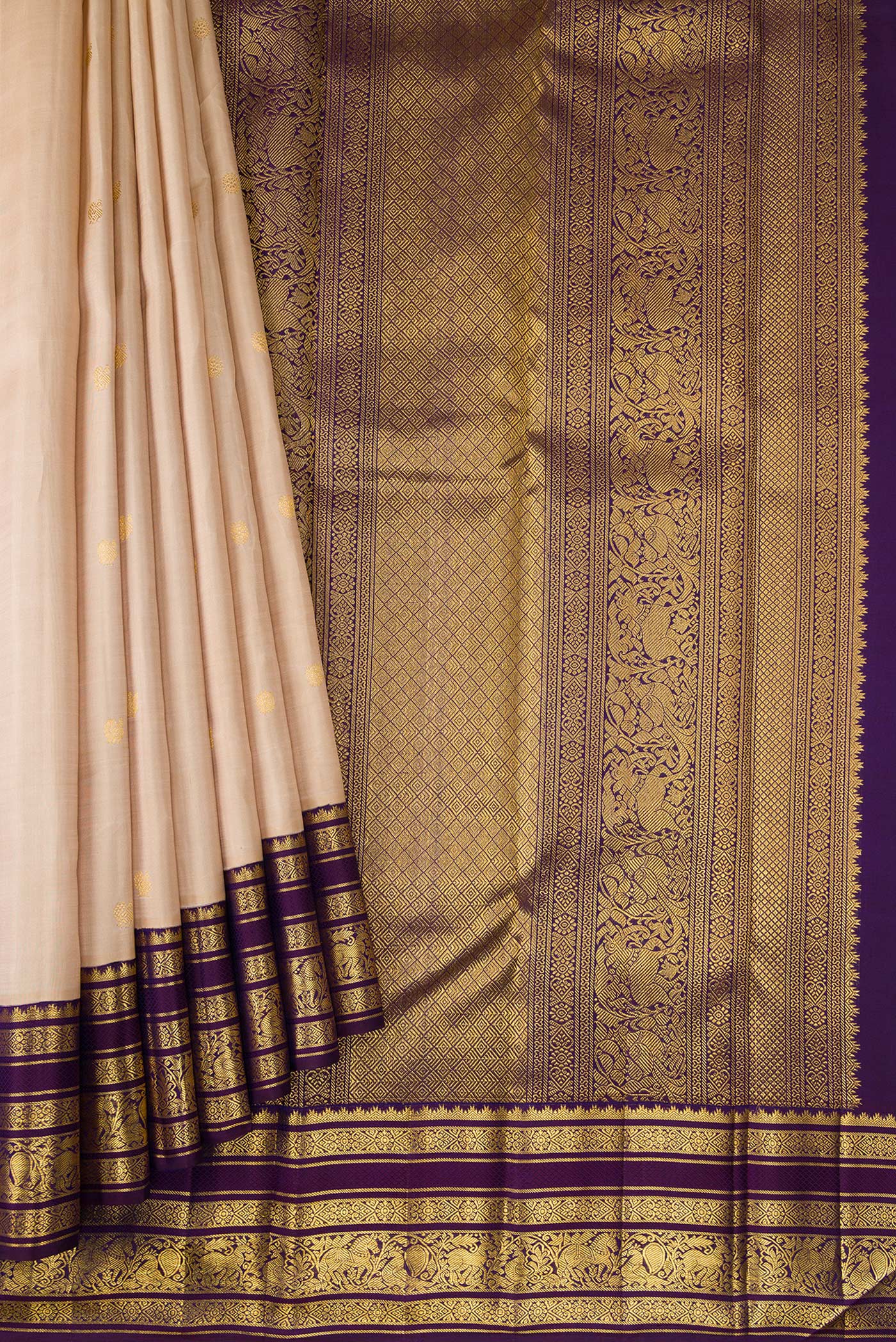 Pleats and pallu of Beige Dual Tone Kanchipuram Silk Saree with Zari Butta on the body and Zari Border. 
