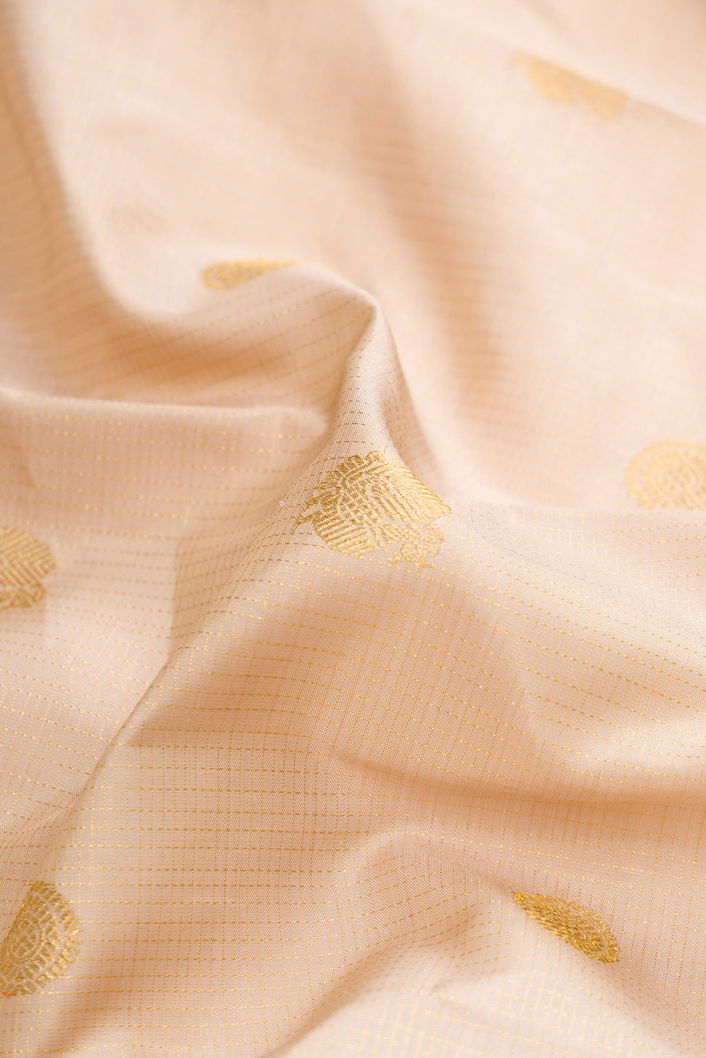 Close up of Dark Beige Dual Tone Kanchipuram Silk Saree with Zari Butta on the body and Zari Border.  displaying folds