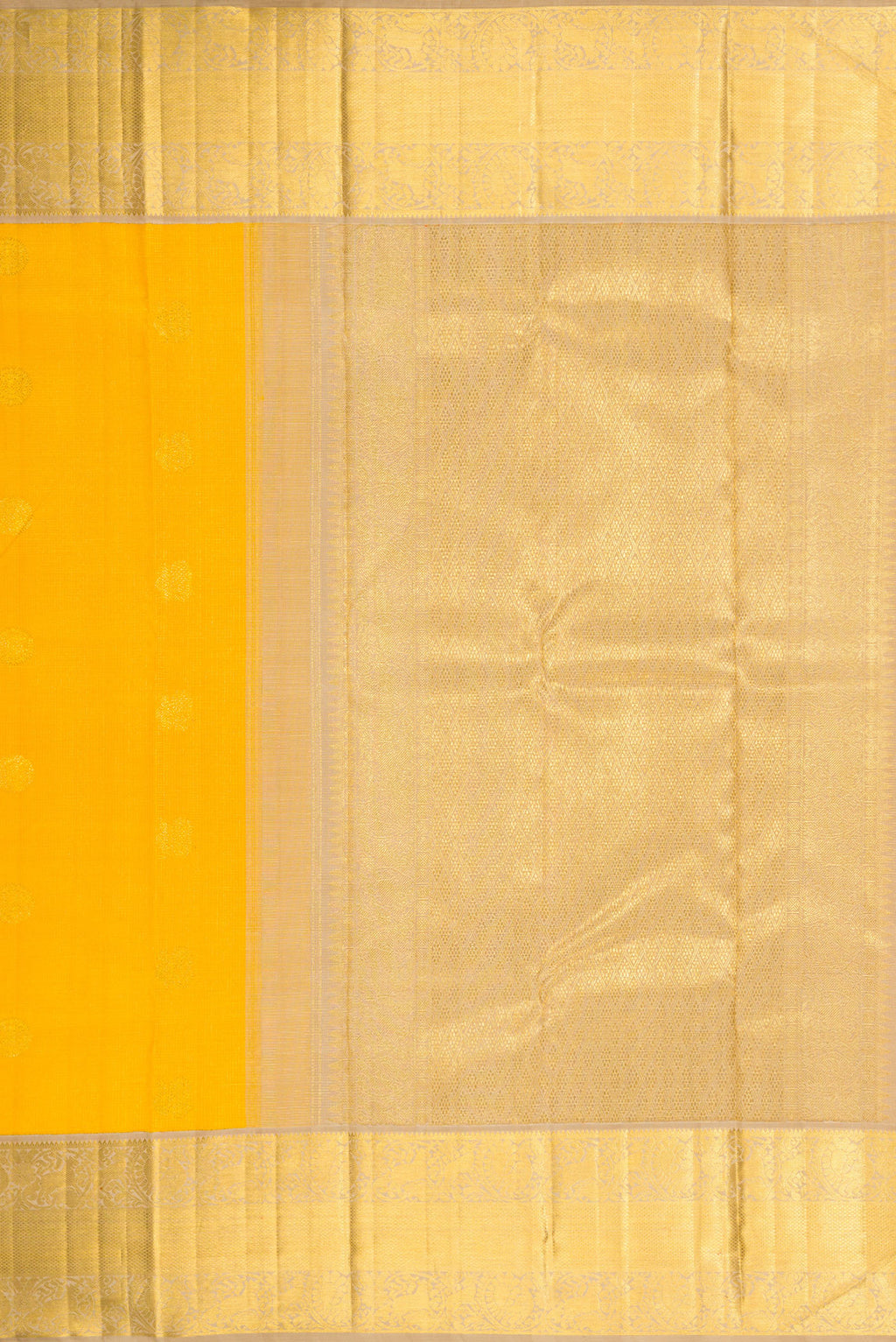 Close up image of the pallu of Yellow Dual Tone Kanchipuram Silk Saree with Zari Butta on the body and Zari Border. 