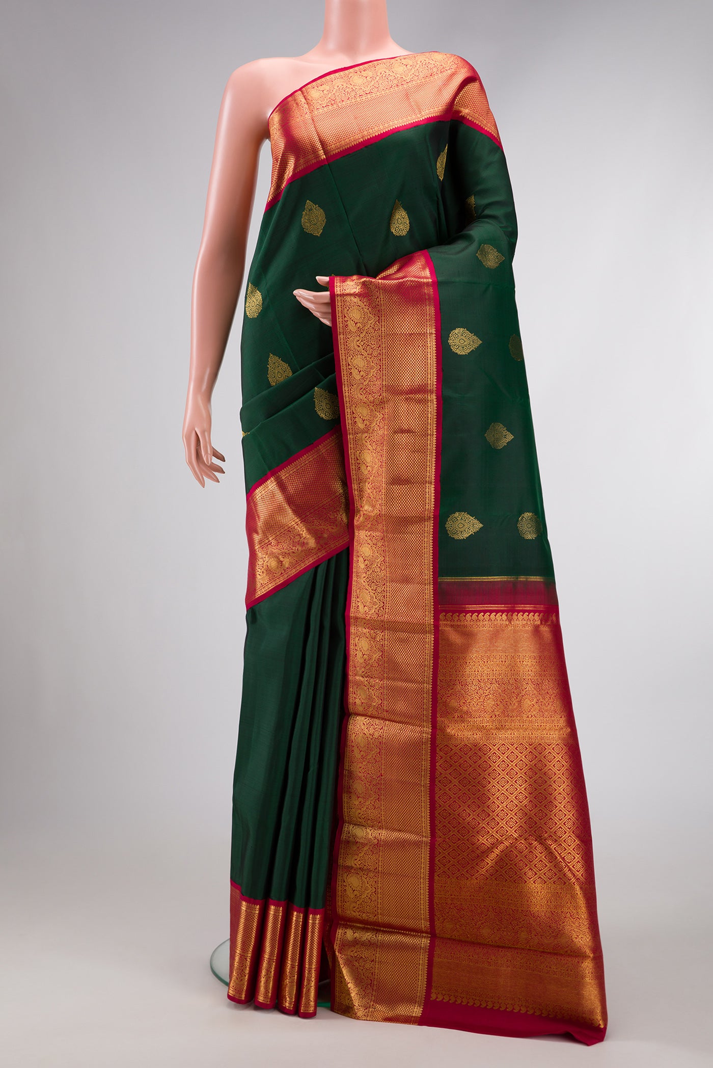 Green Dual Tone Kanchipuram Silk Saree with Zari Butta on the body and Zari Border.  displayed on a mannequin