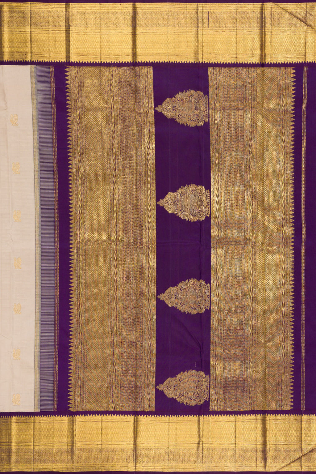 Close up image of the pallu of Beige Kanchipuram Silk Saree with Zari Butta on the body and Zari Border. 