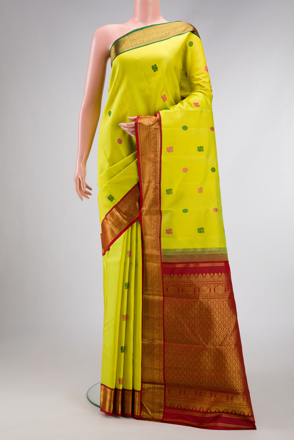 Pure Silk Pure Zari Lemon Yellow Dual Tone Kanjivaram Saree with Thread Butta on the body and Ganga Jamuna Border.  displayed on a mannequin