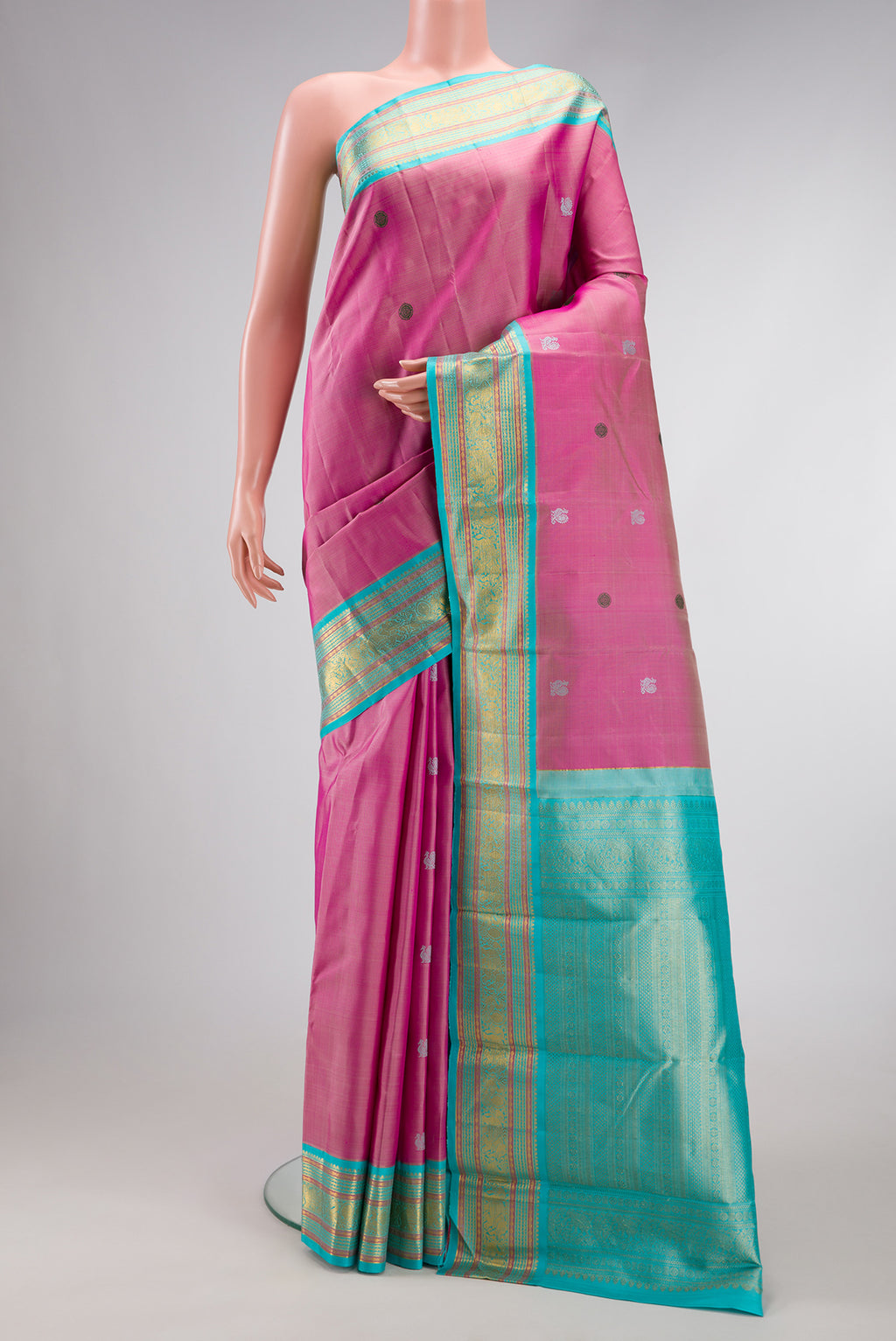 Pink Dual Tone Kanjivaram Silk Saree with Thread Butta on the body and Zari Border.  displayed on a mannequin