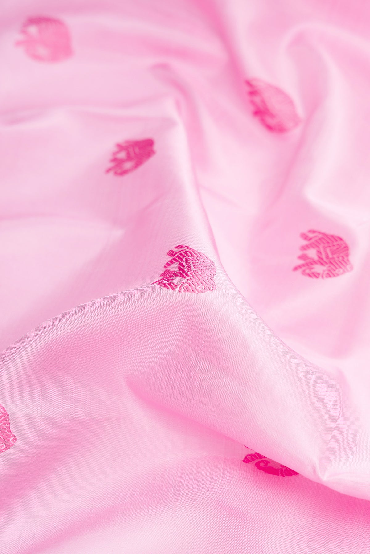 Close up of Pure Silk Pure Zari Rose pink Dual Tone Kanchipuram Saree with Thread Butta on the body and Fancy Border.  displaying folds
