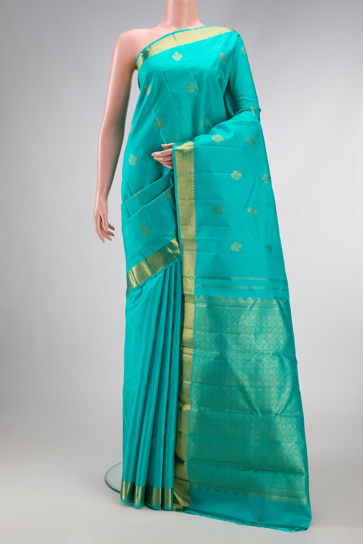 Sea Green Dual Tone Kanjivaram Silk Saree with Zari Butta on the body and Zari Border.  displayed on a mannequin