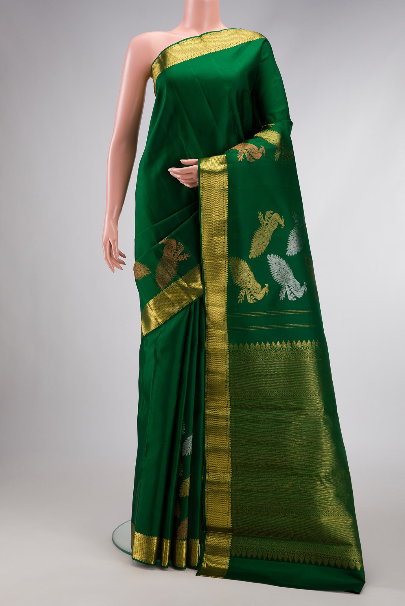 Pure Silk Pure Zari Green Dual Tone Kanjivaram Saree with Plain Body and Fancy Border.  displayed on a mannequin