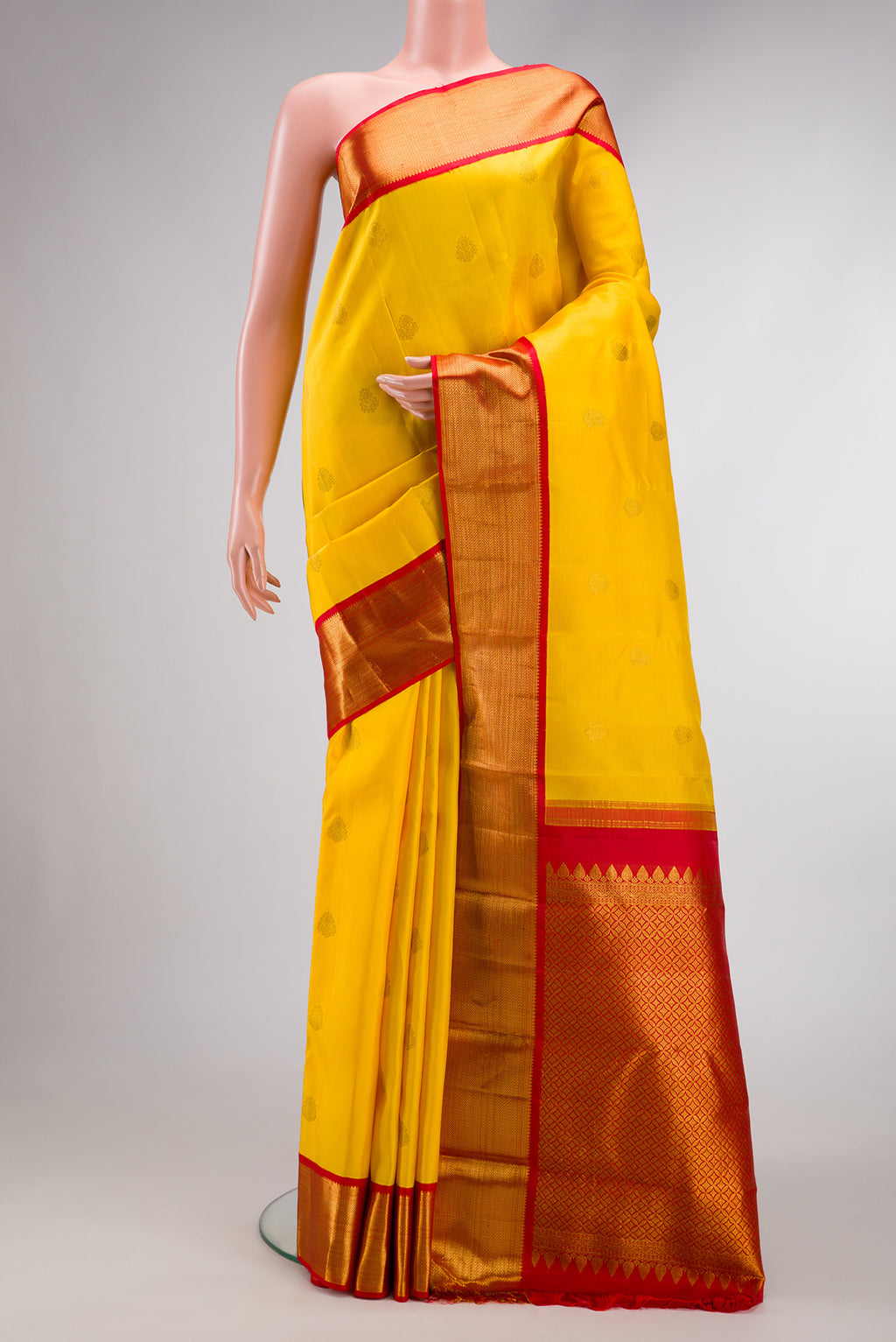 Pure Silk Pure Zari Yellow Dual Tone Kanjivaram Saree with Zari Butta on the body and Zari Border.  displayed on a mannequin