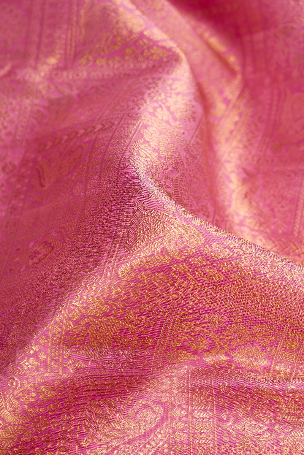 Close up of Pure Silk Pure Zari Pink Dual Tone Kanjivaram Saree with Zari Brocade on the body and Zari Border.  displaying folds