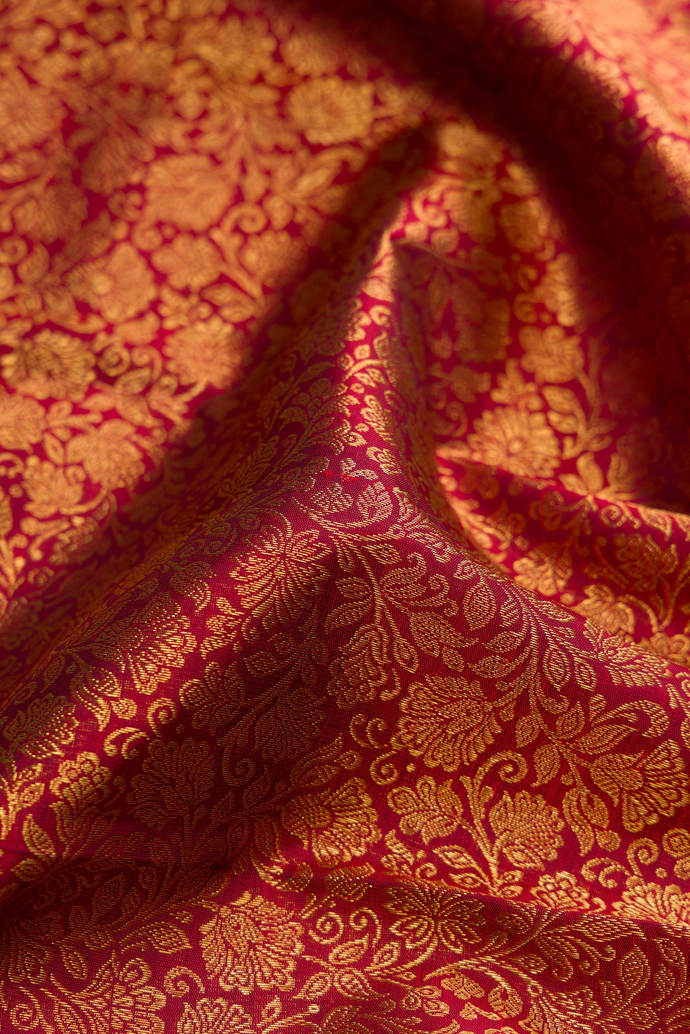 Close up of Pure Silk Pure Zari Maroon Kanjivaram Saree with Zari Brocade on the body and Zari Border.  displaying folds