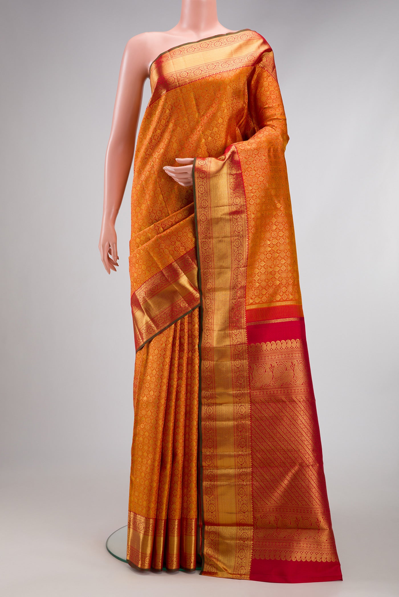 Pure Silk Pure Zari Mustard Dual Tone Kanjivaram Saree with Zari Brocade on the body and Zari Border.  displayed on a mannequin