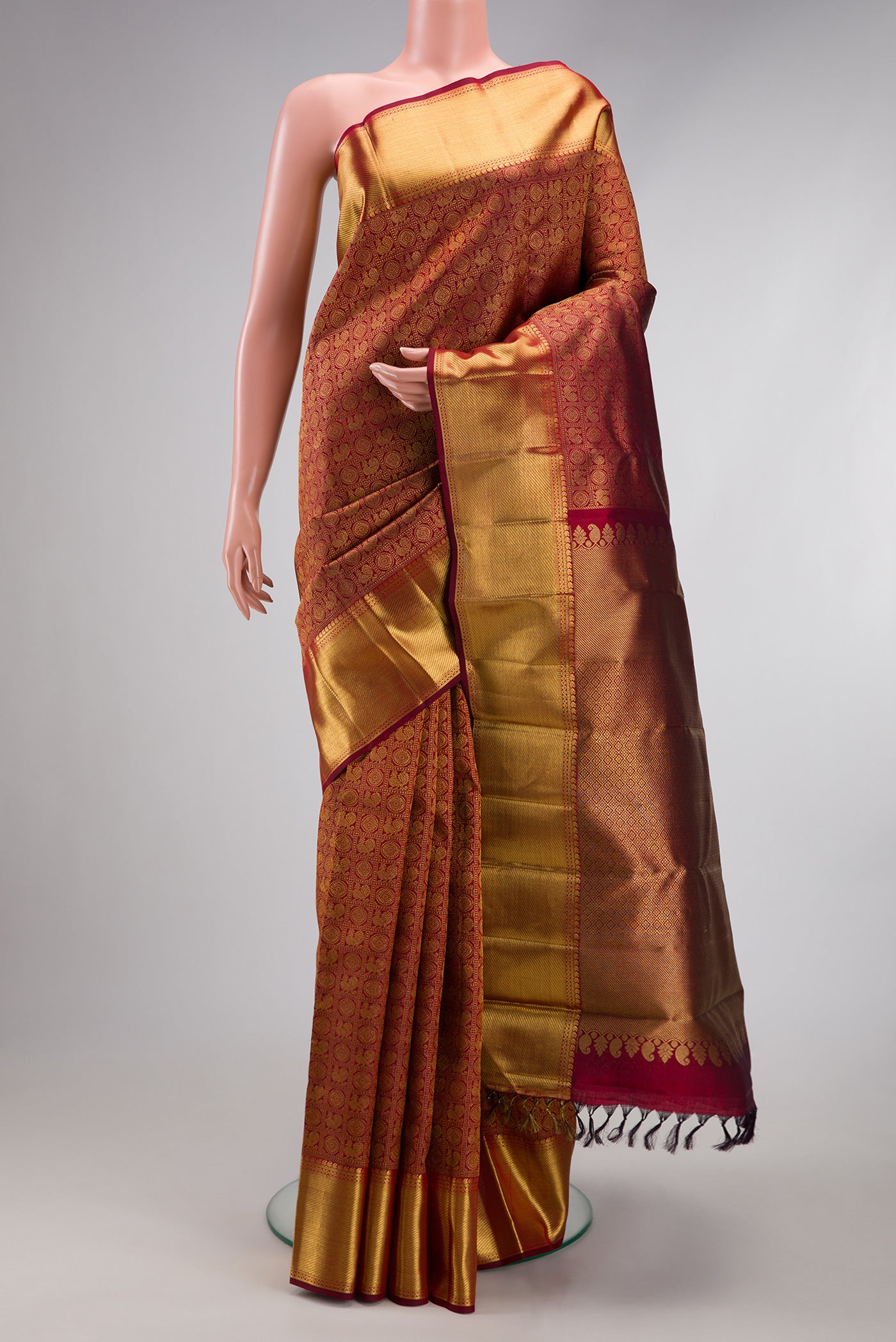 Pure Silk Pure Zari Maroon Kanjivaram Saree with Zari Brocade on the body and Zari Border.  displayed on a mannequin