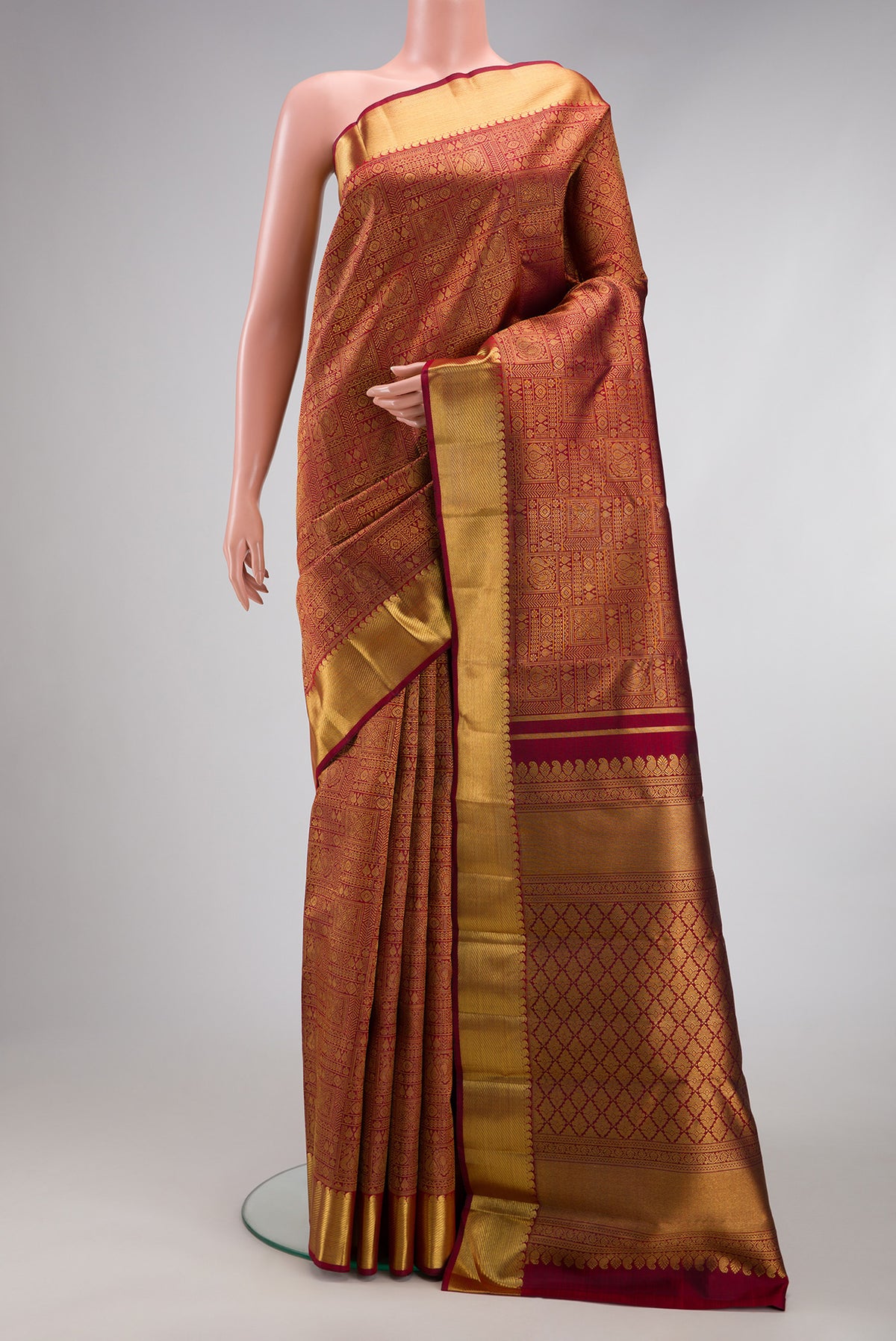 Pure Silk Pure Zari Maroon Kanjivaram Saree with Zari Brocade on the body and Zari Border.  displayed on a mannequin
