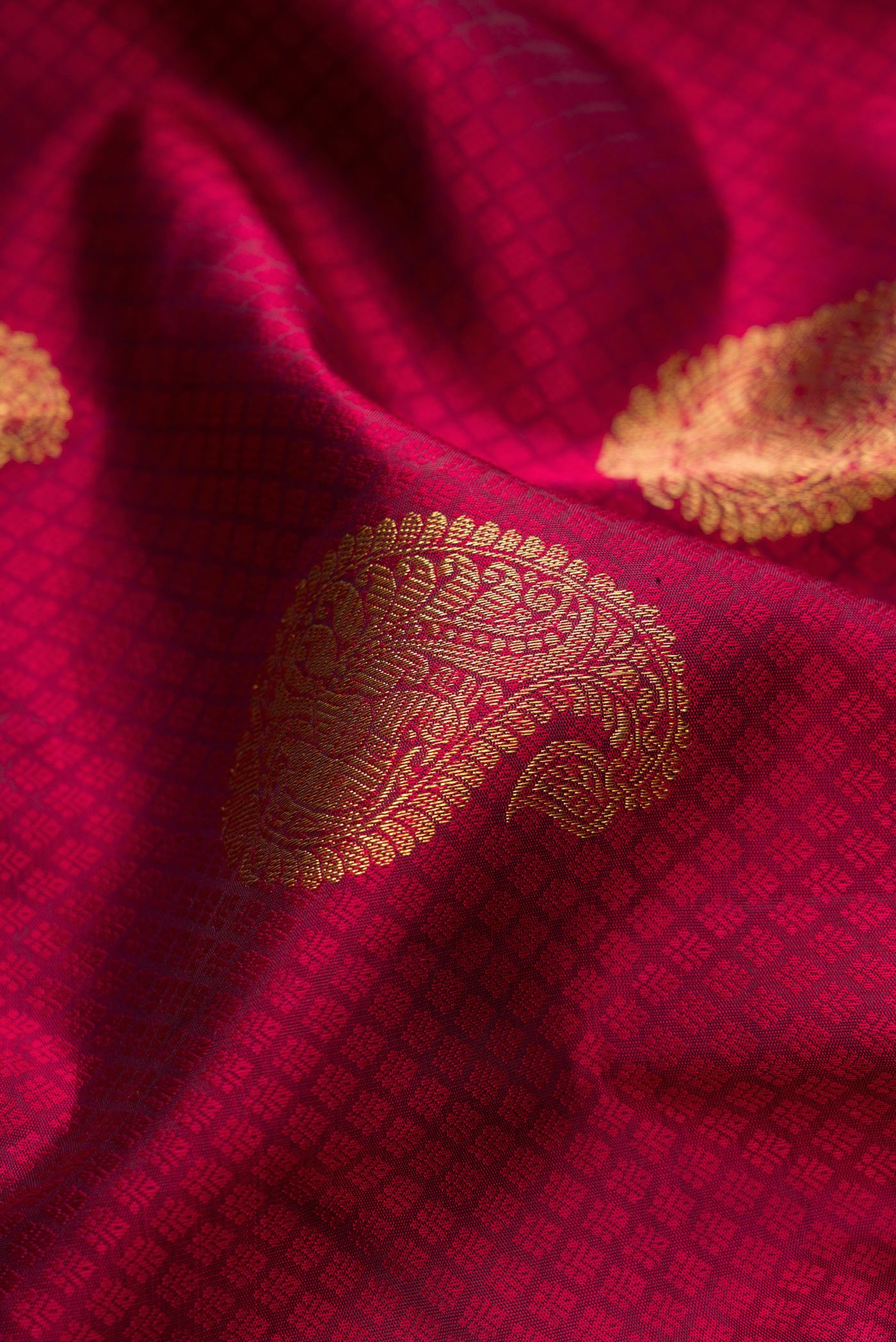 Close up of Pure Silk Pure Zari Maroon Kanjivaram Saree with Jacquard With Zari Butta on the body and Zari Border.  displaying folds