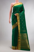 Pure Silk Pure Zari Green Dual Tone Kanjivaram Saree with Zari Butta on the body and Zari Border.  displayed on a mannequin