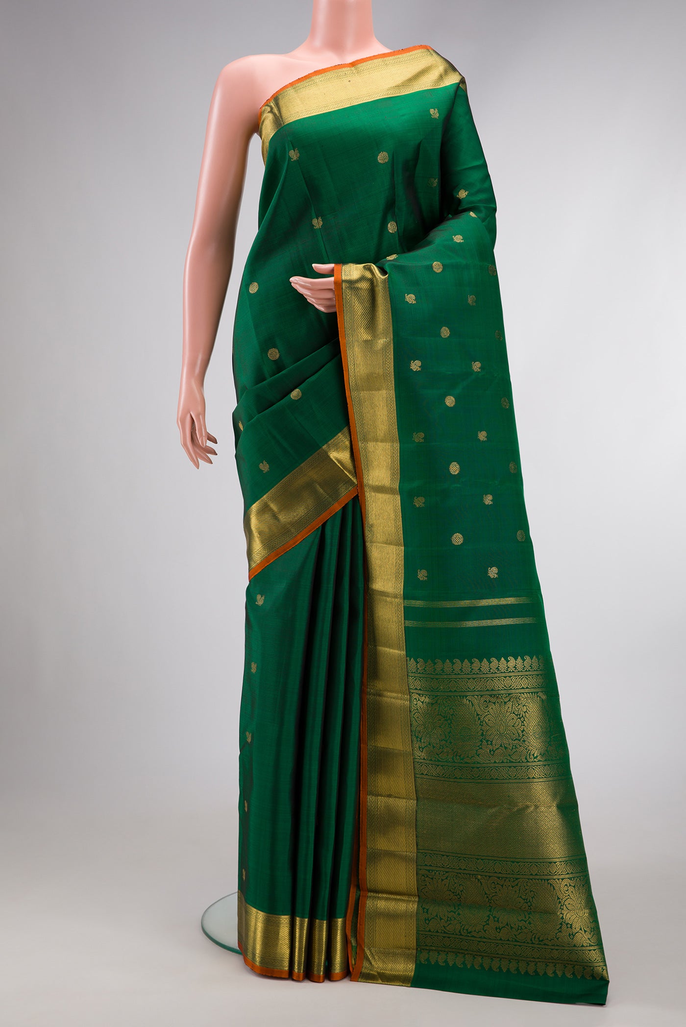 Pure Silk Pure Zari Green Dual Tone Kanjivaram Saree with Zari Butta on the body and Zari Border.  displayed on a mannequin
