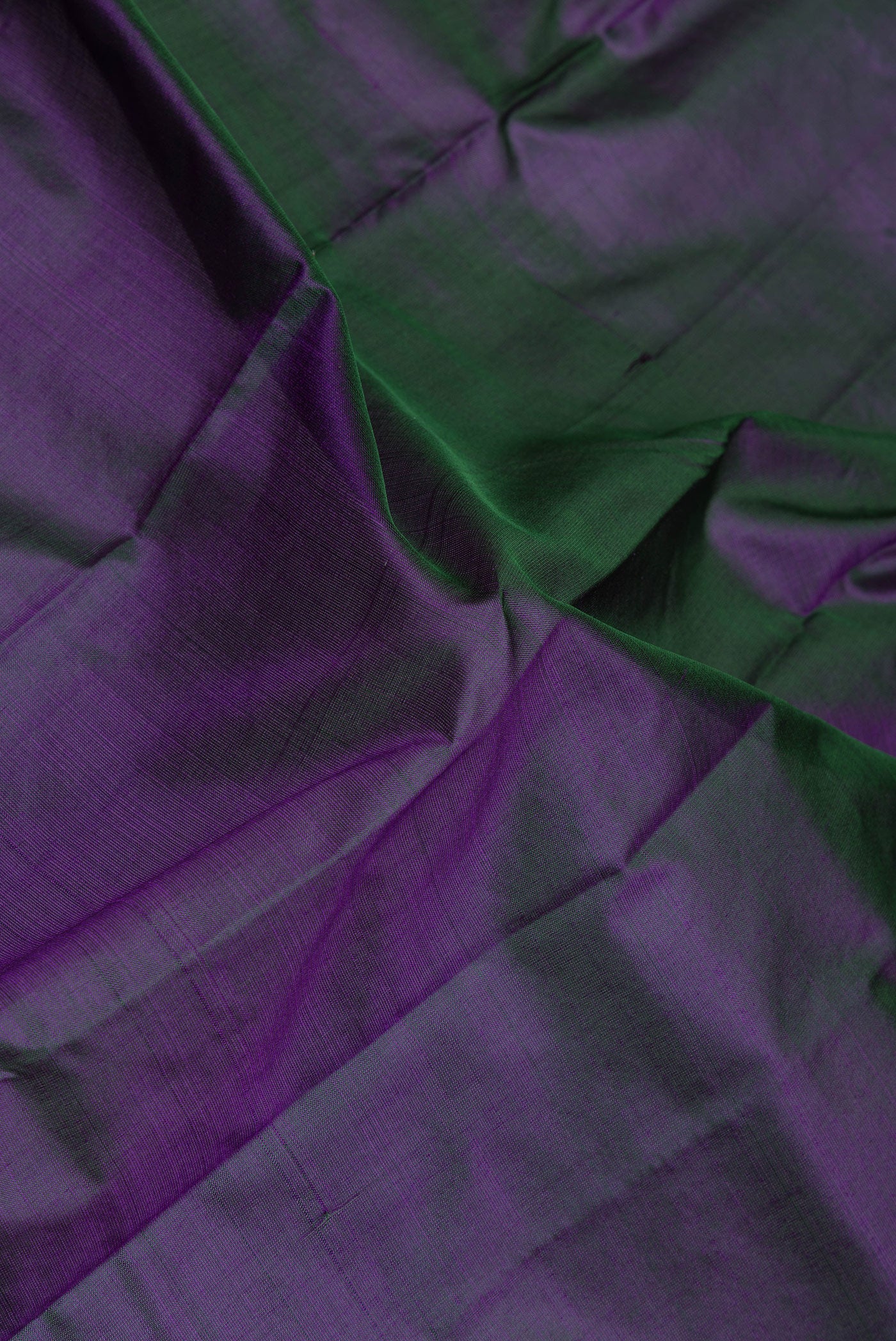 Close up of Peacock Blue Dual Tone Kanjivaram Silk Saree with Plain Body and Zari Border.  displaying folds