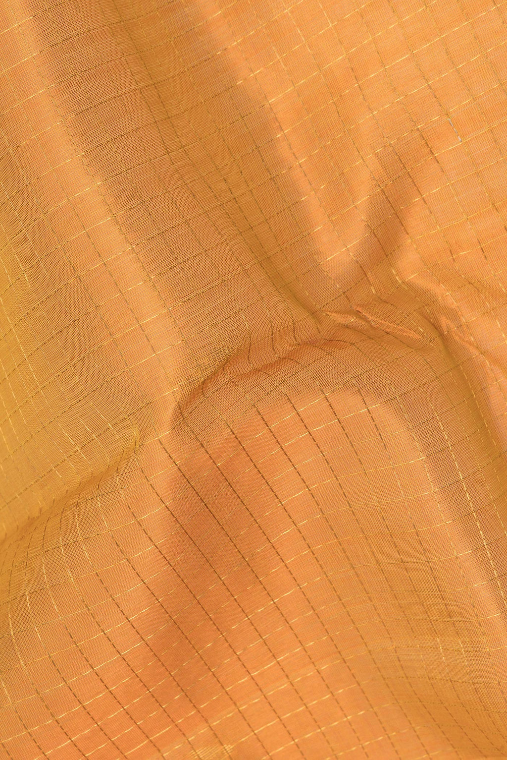 Close up of Mustard Silk Cotton Saree with Checked design on the body and Zari Border.  displaying folds