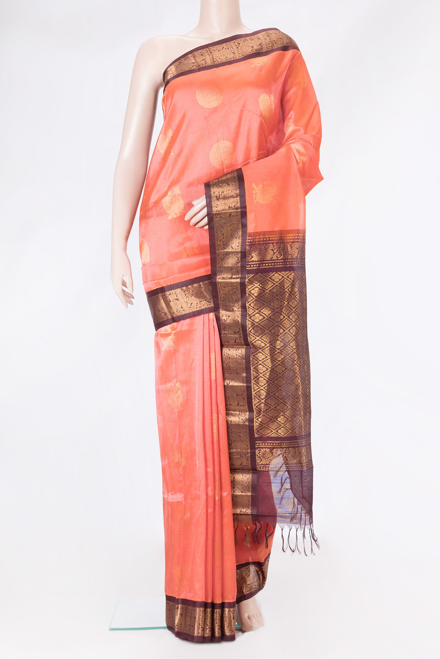 Peach Dual Tone Silk Cotton Saree with Zari Butta on the body and Zari Border.  displayed on a mannequin