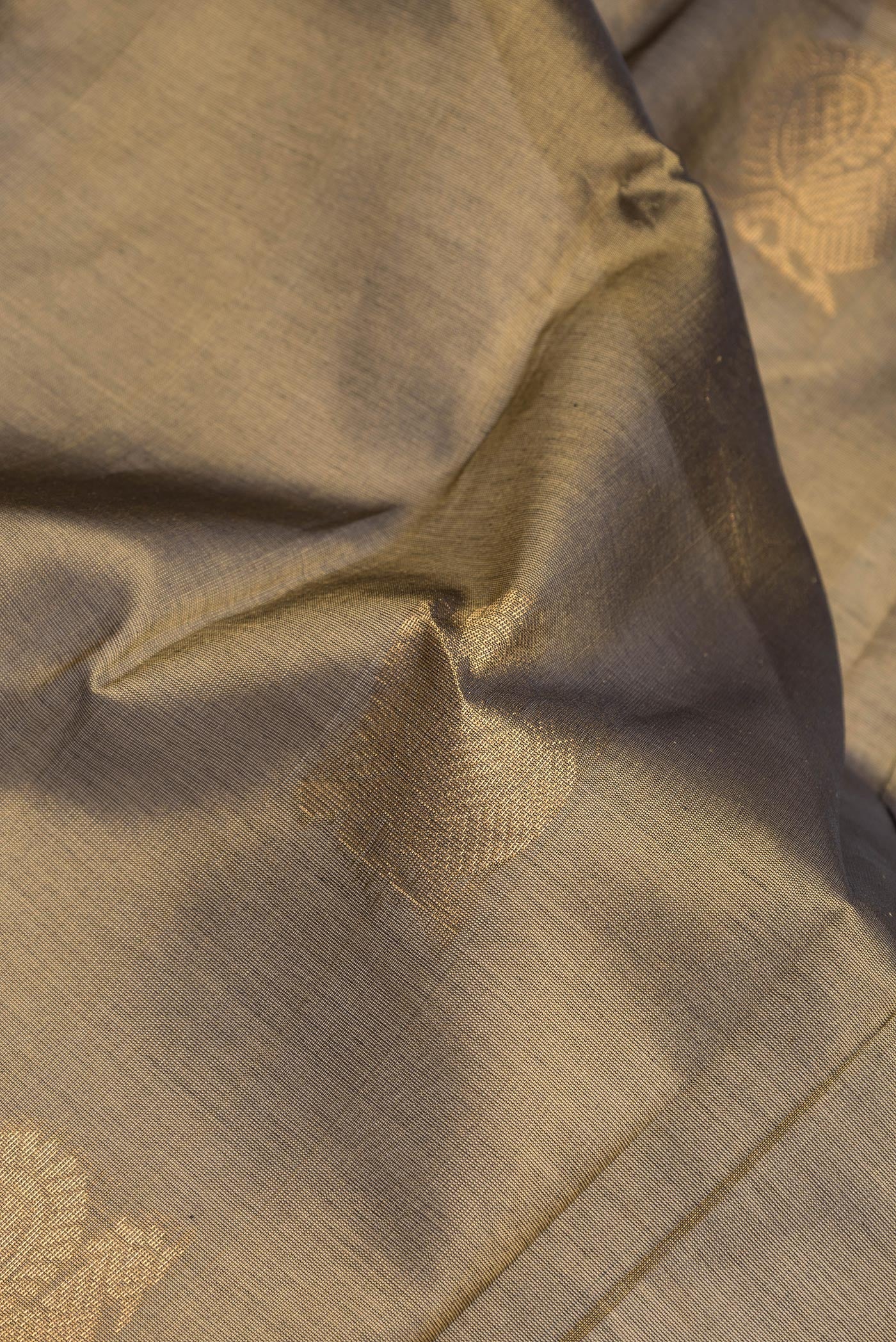 Close up of Mehandi Green Dual Tone Silk Cotton Saree with Zari Butta on the body and Zari Border.  displaying folds