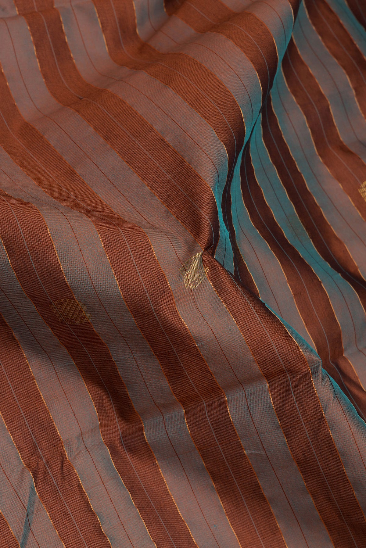 Close up of Brown Silk Cotton Saree with Stripes on the body and Zari Border.  displaying folds
