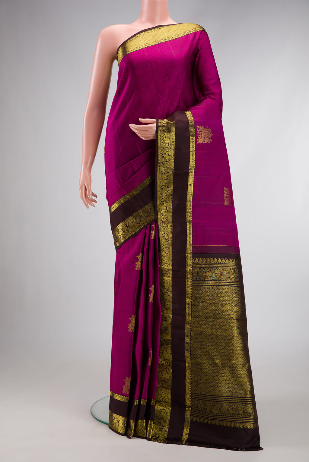 Magenta Dual Tone Kanjivaram Silk Saree with Zari Butta on the body and Zari Border.  displayed on a mannequin