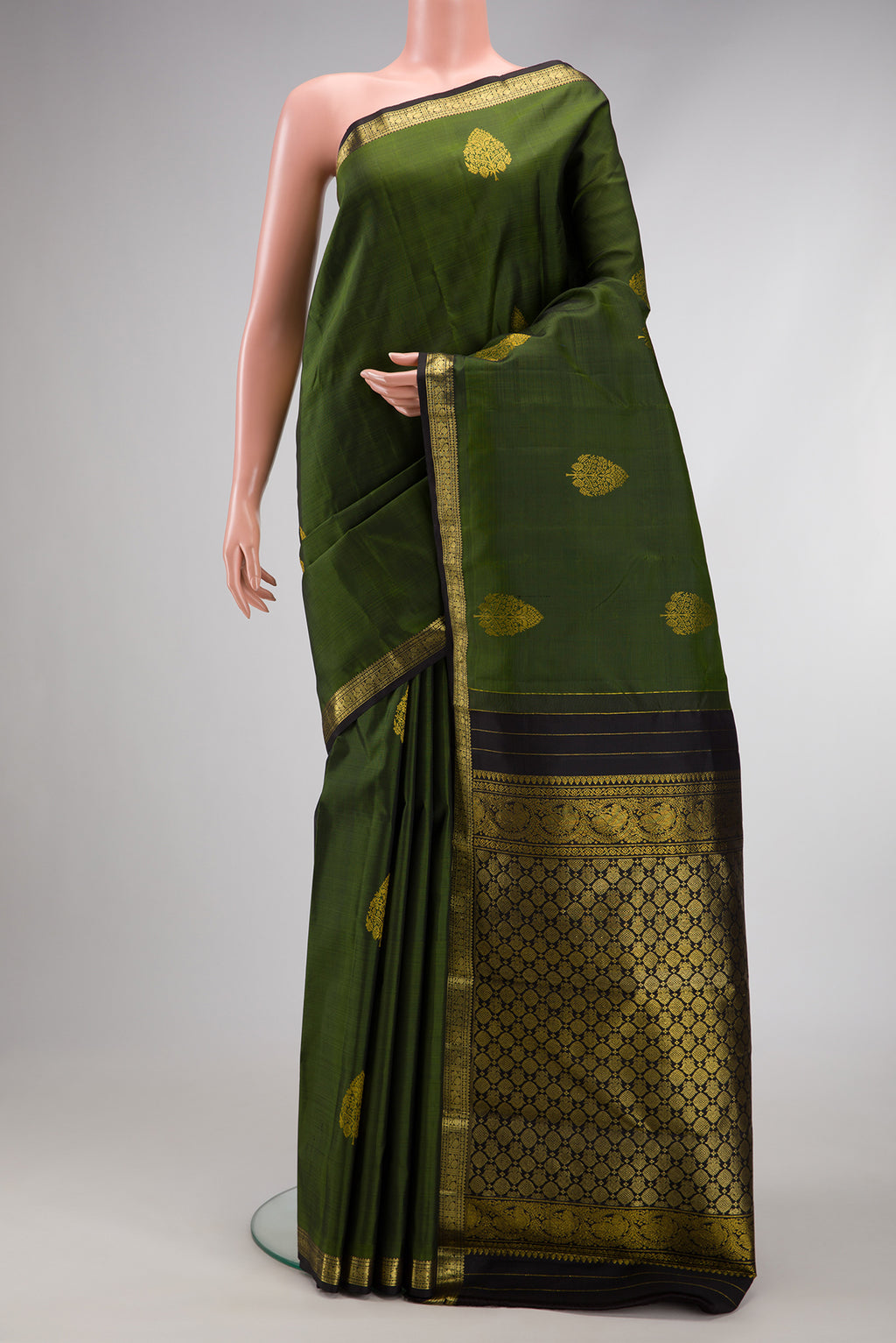 Mehandi Green Dual Tone Kanjivaram Silk Saree with Zari Butta on the body and Zari Border.  displayed on a mannequin