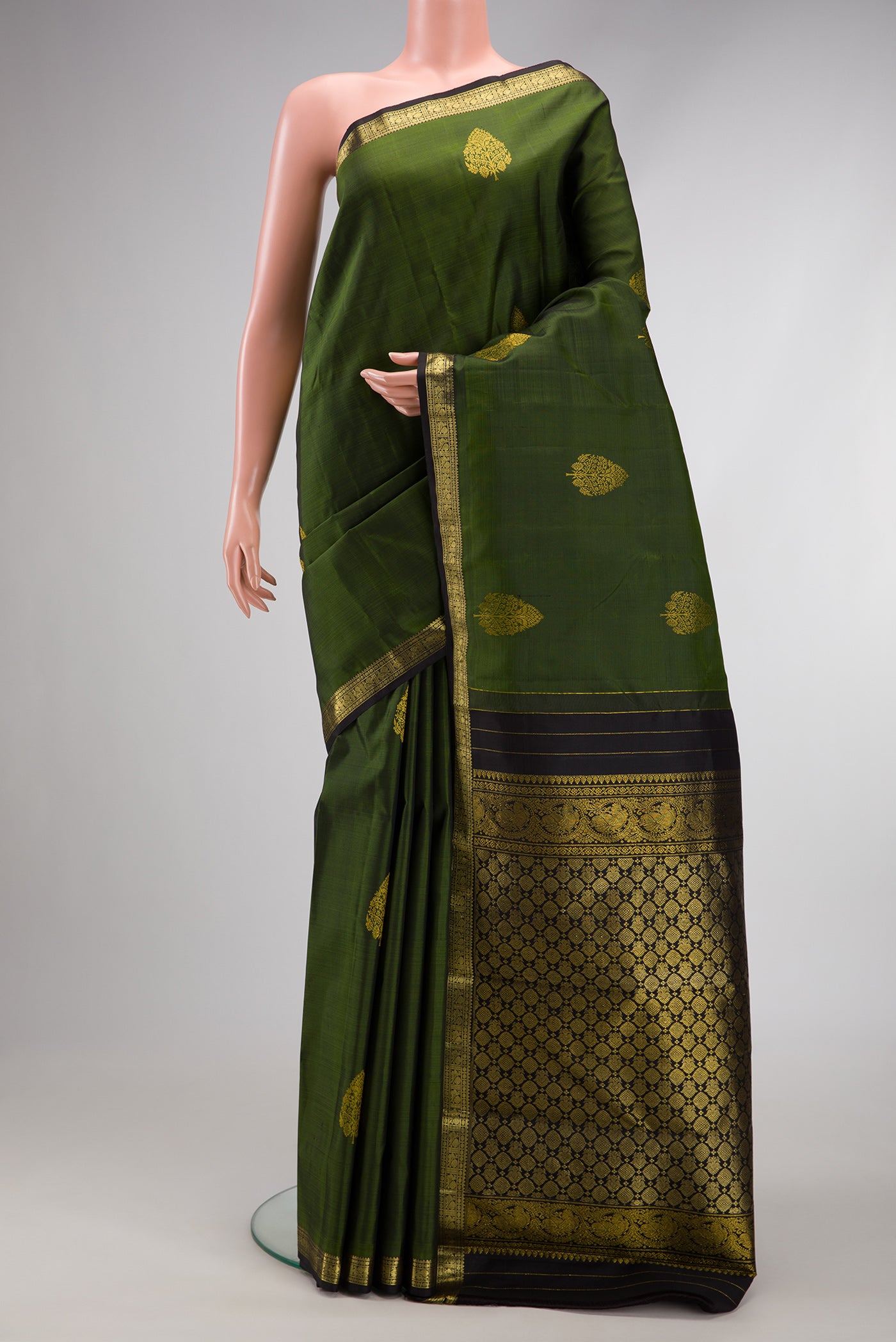 Mehandi Green Dual Tone Kanjivaram Silk Saree with Zari Butta on the body and Zari Border.  displayed on a mannequin