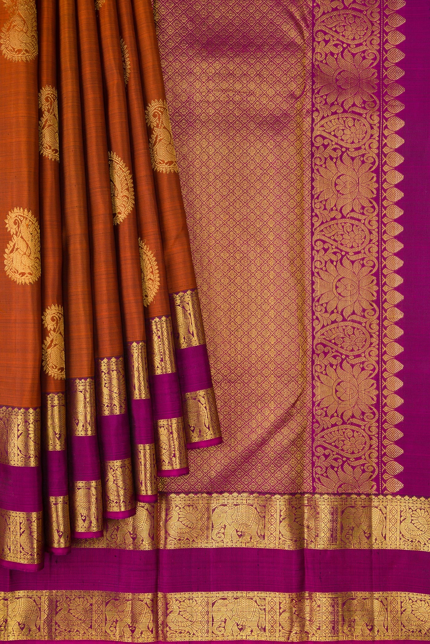 Pleats and pallu of Brick Orange Kanjivaram Silk Saree with Zari Butta on the body and Zari Border. 