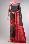 Mehandi Green Dual Tone Kanjivaram Silk Saree with Zari Butta on the body and Zari Border.  displayed on a mannequin