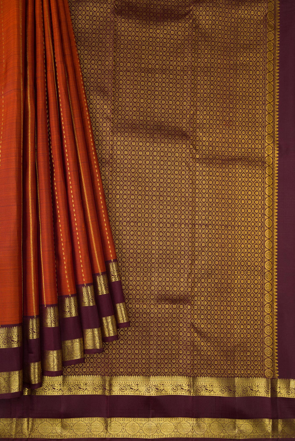 Pleats and pallu of Brick Orange Dual Tone Kanjivaram Silk Saree with Stripes on the body and Zari Border. 