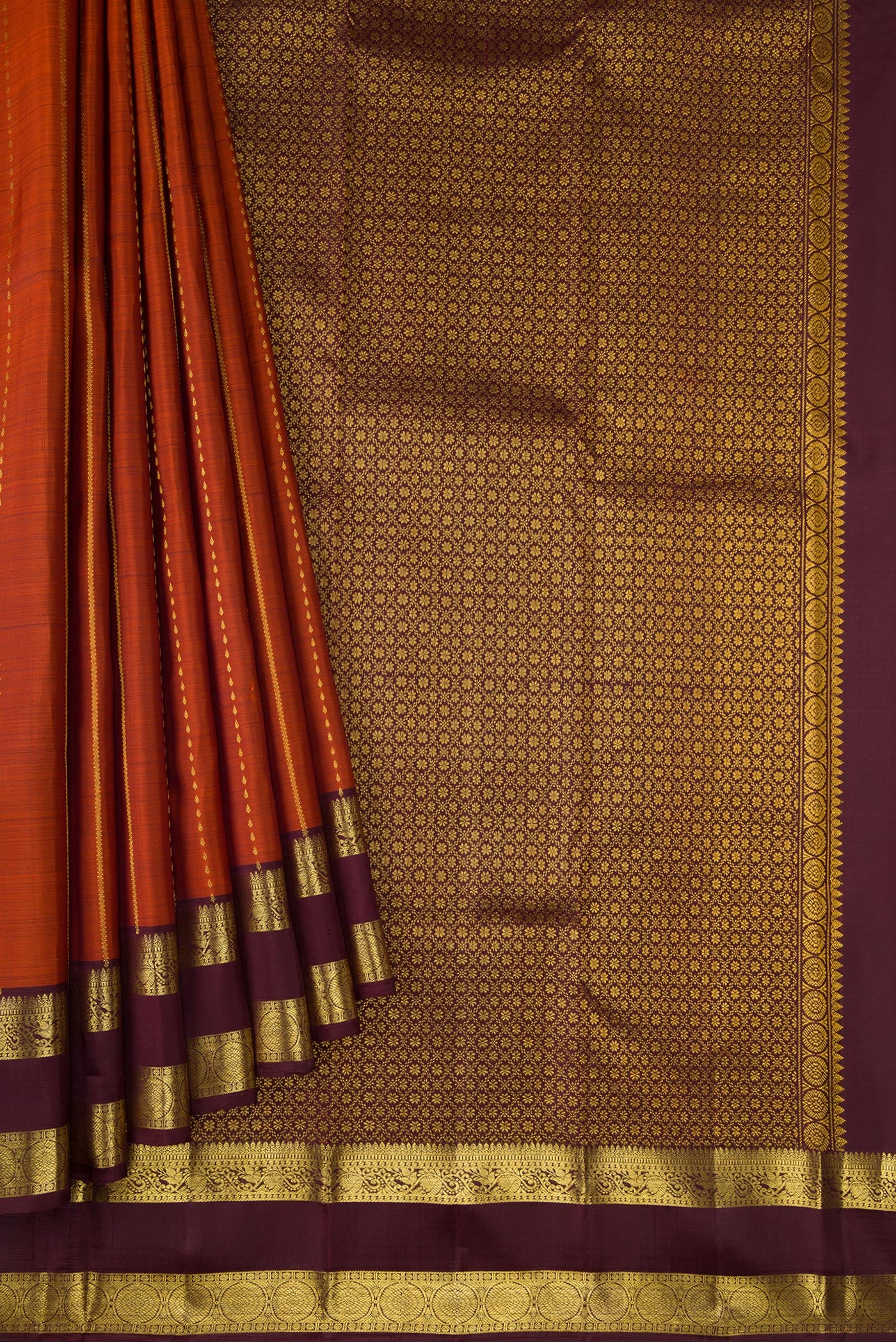 Pleats and pallu of Brick Orange Dual Tone Kanjivaram Silk Saree with Stripes on the body and Zari Border. 